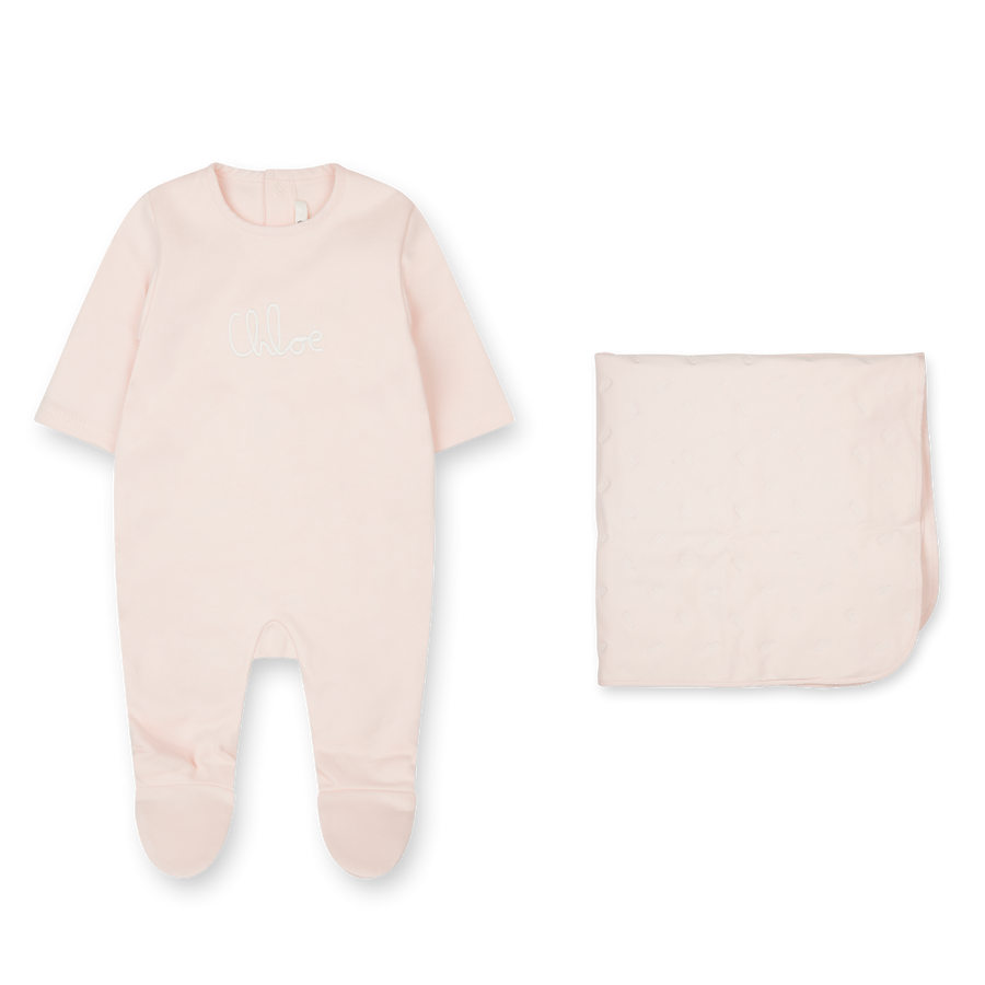 Baby onesie with footies and matching bag on a white background