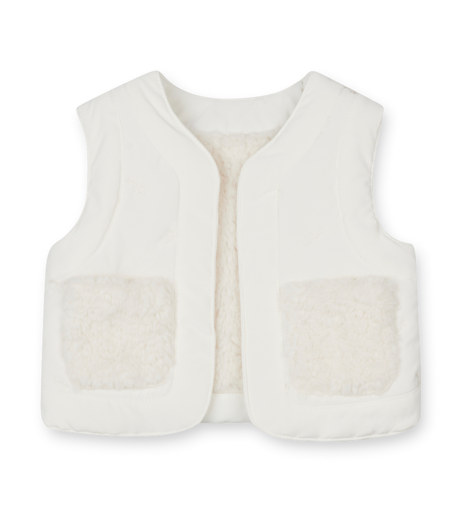 White quilted vest on a white background