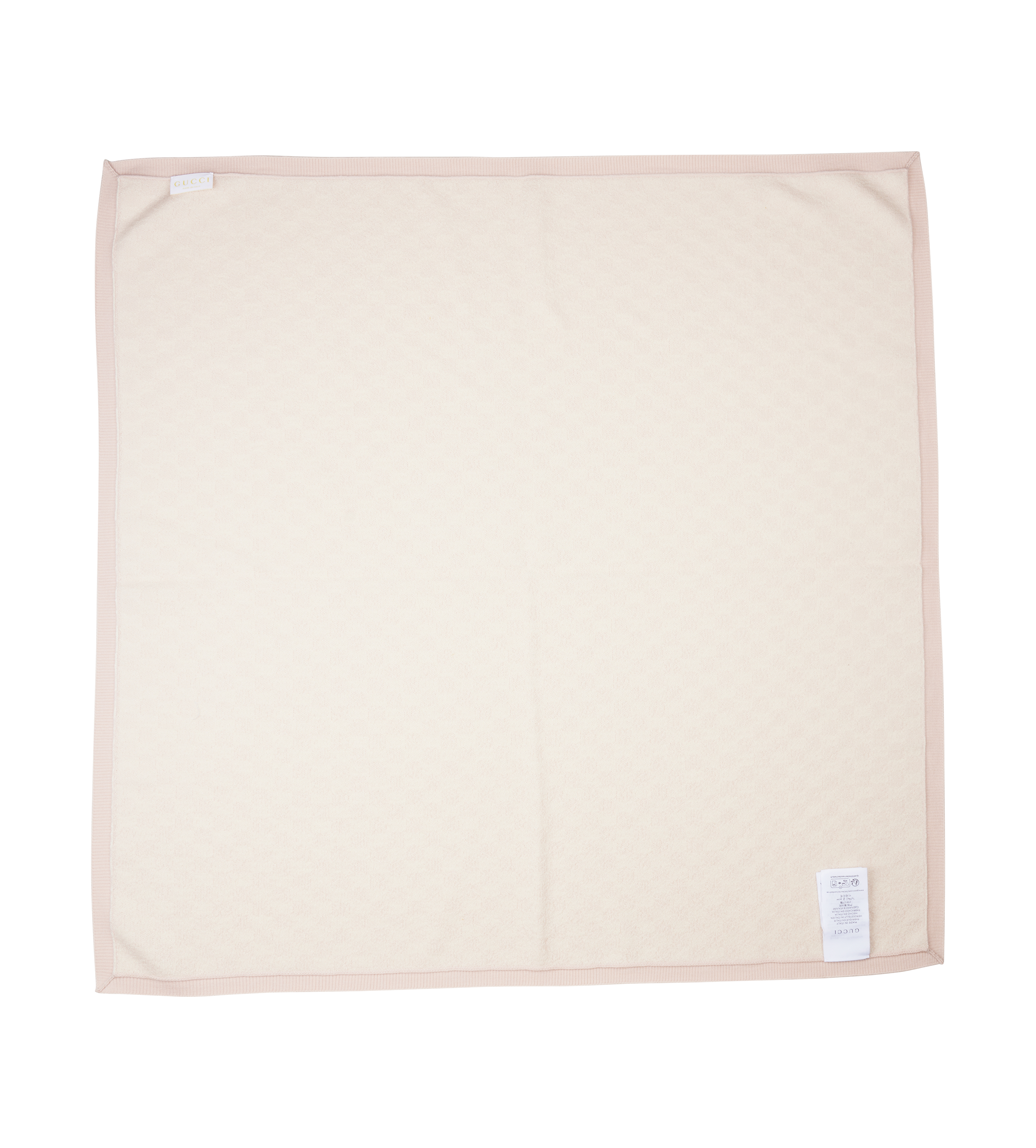 Beige blanket with a small label on a white background