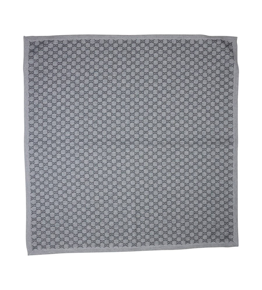 Gray patterned fabric square on a white background