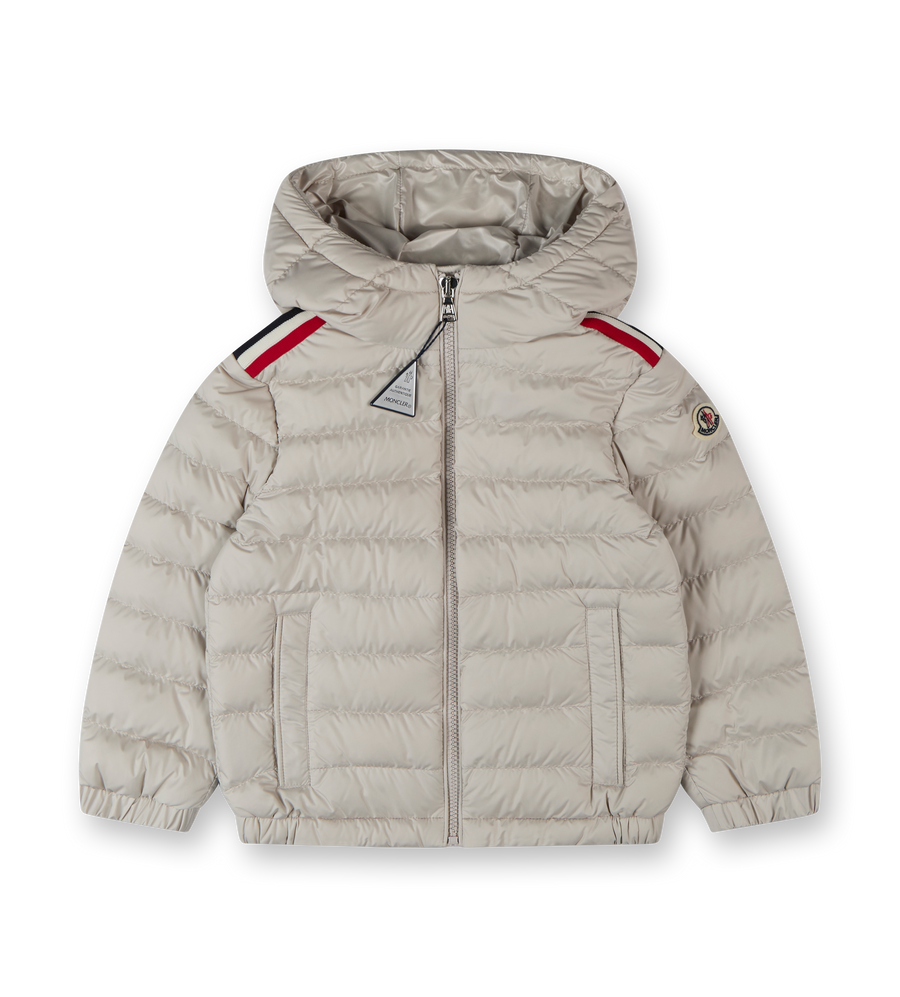 A beige Moncler hooded down jacket for boys with red trim on the shoulders and a zip closure.
