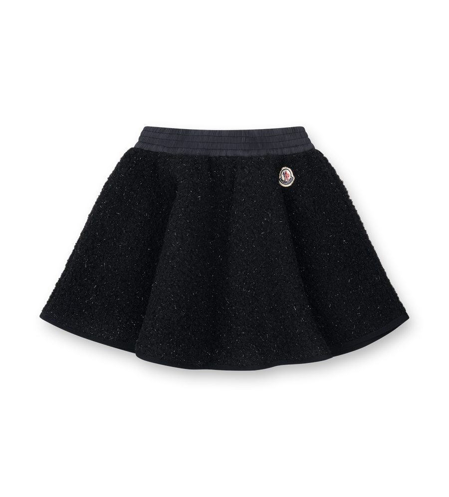 Black skirt with a button on a white background