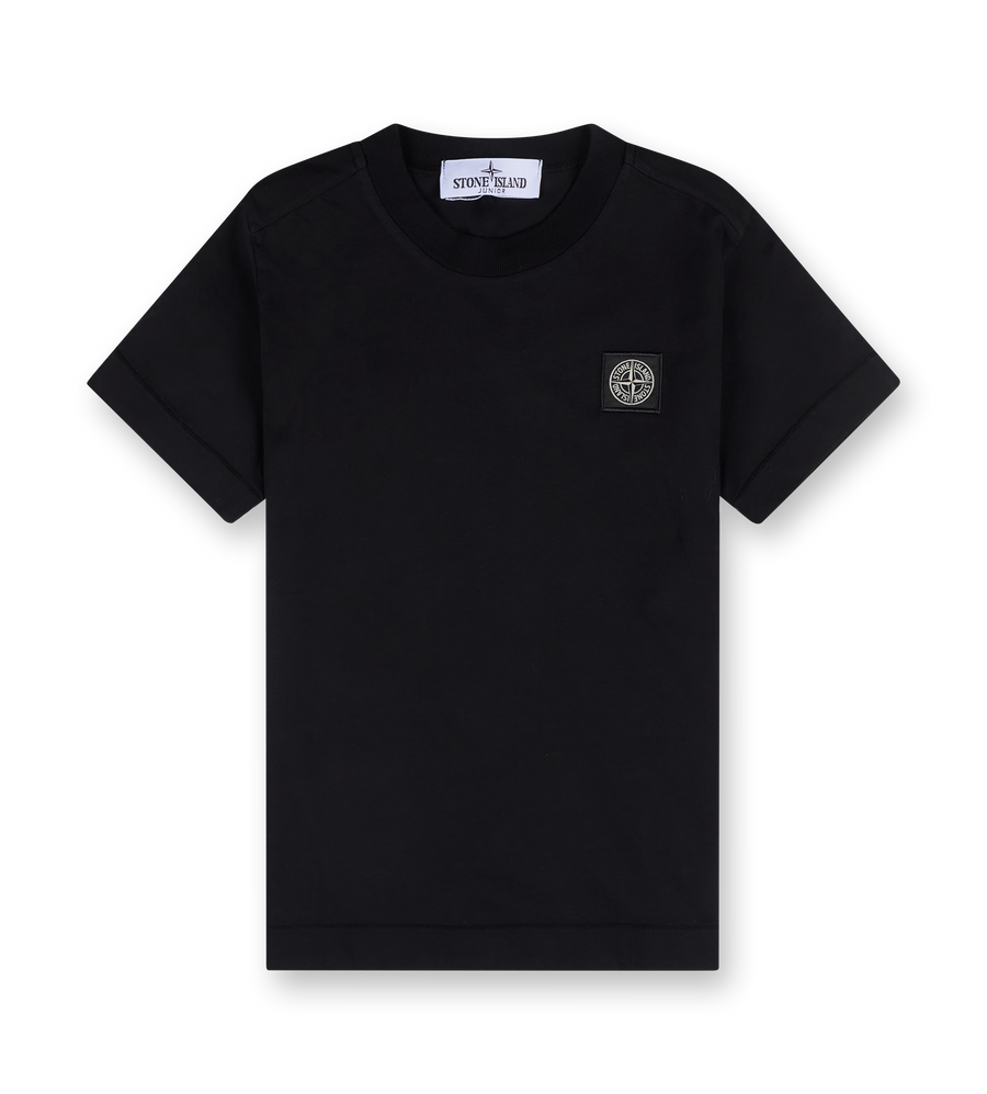 A black crew neck T-shirt with short sleeves and a straight hem. The logo of Stone Island Junior is visible on the chest.