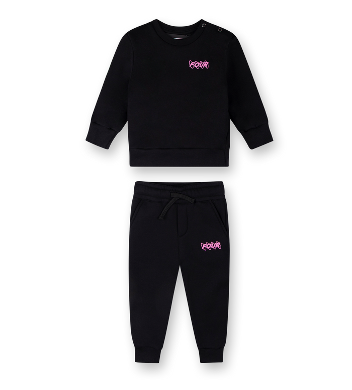 A set of baby clothing, including a black crewneck sweatshirt with a pink circle logo on the chest and black sweatpants with a matching pink logo on the front.