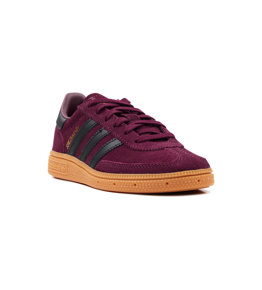 Maroon sneaker with brown sole on a white background