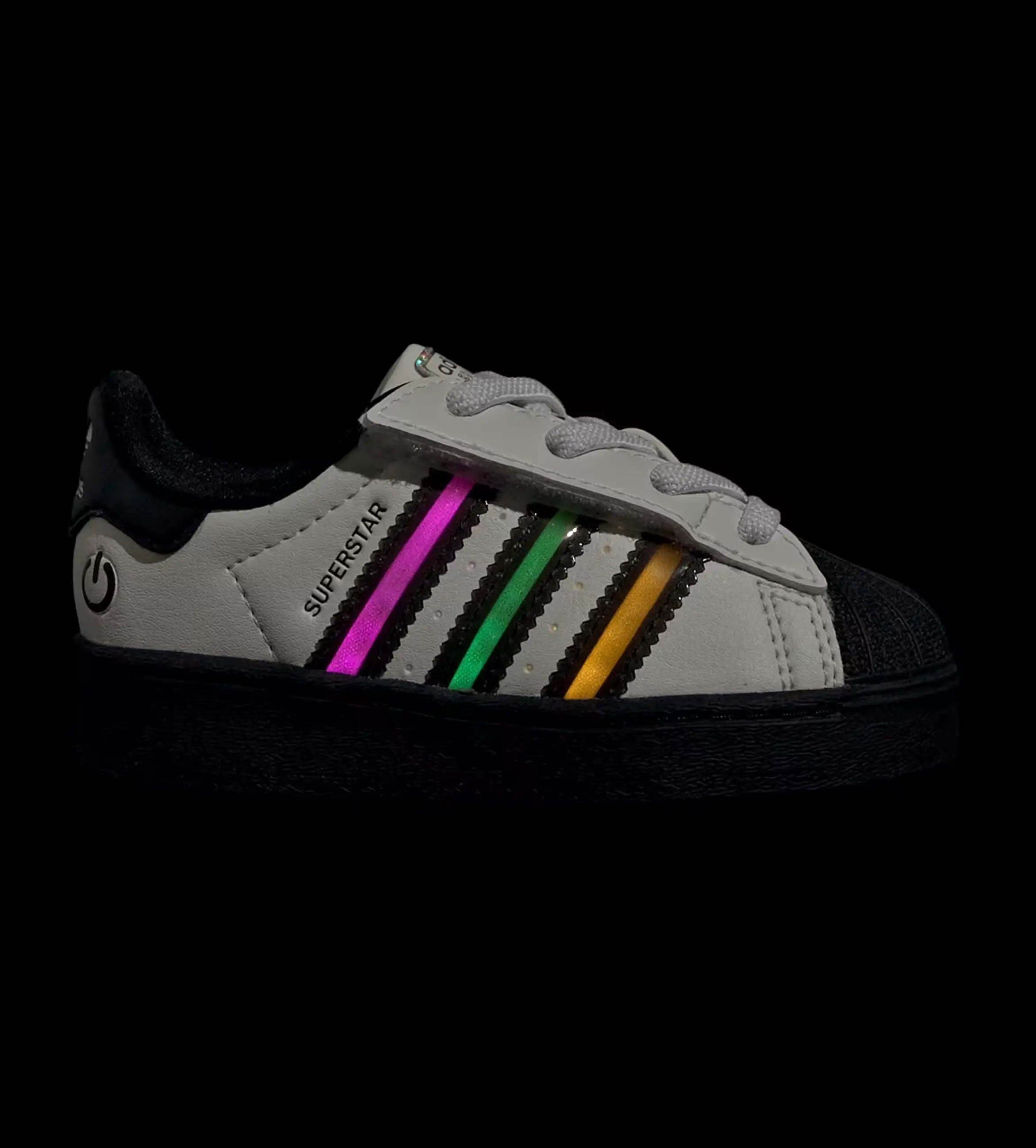 White sneaker with colorful LED stripes on a black background
