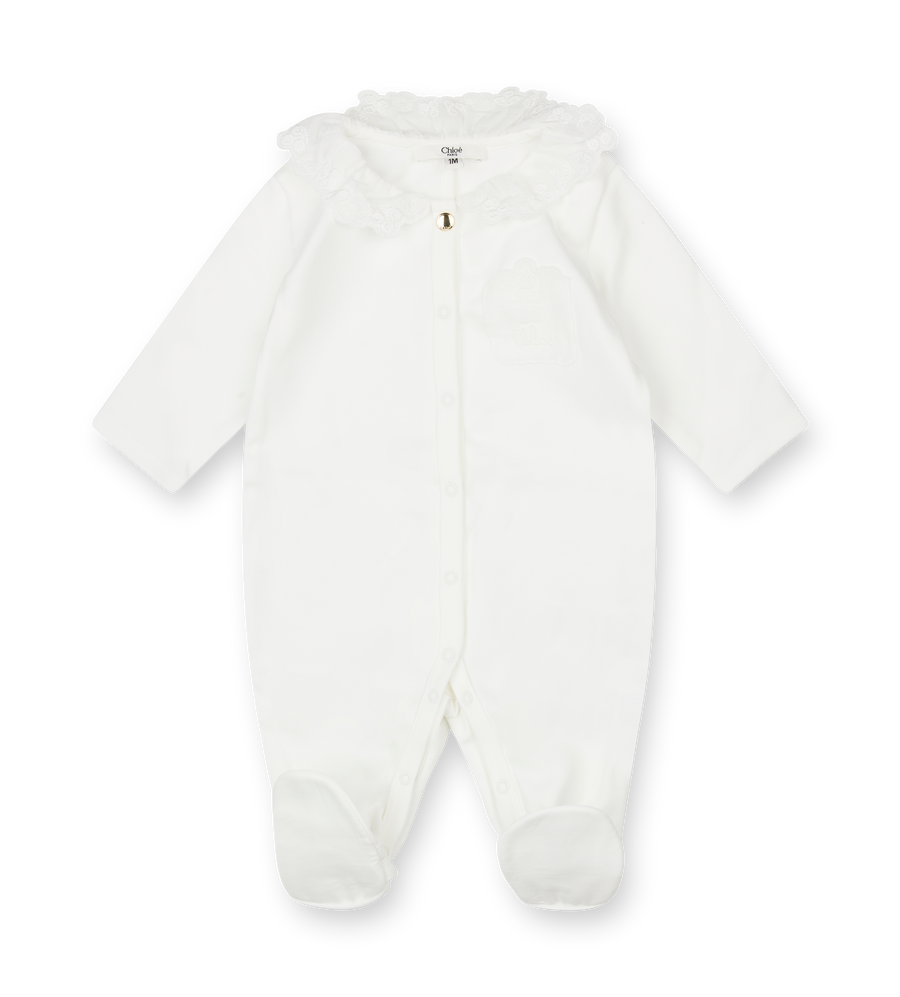 White baby onesie with a hood on a white background