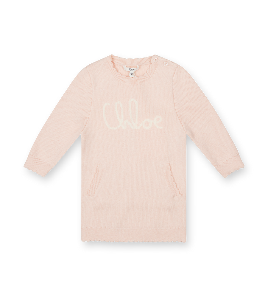 Beige long-sleeve dress with 'COCO' print on a white background