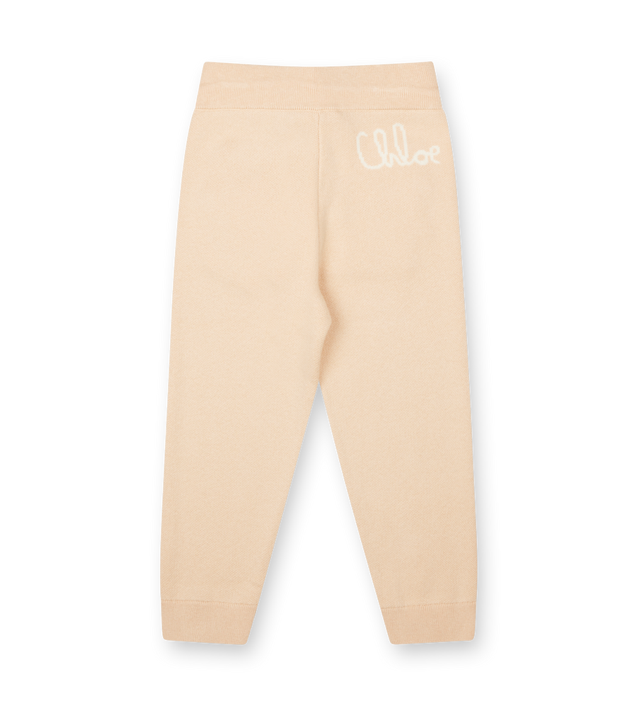 Beige leggings with 'Chloe' branding on a white background