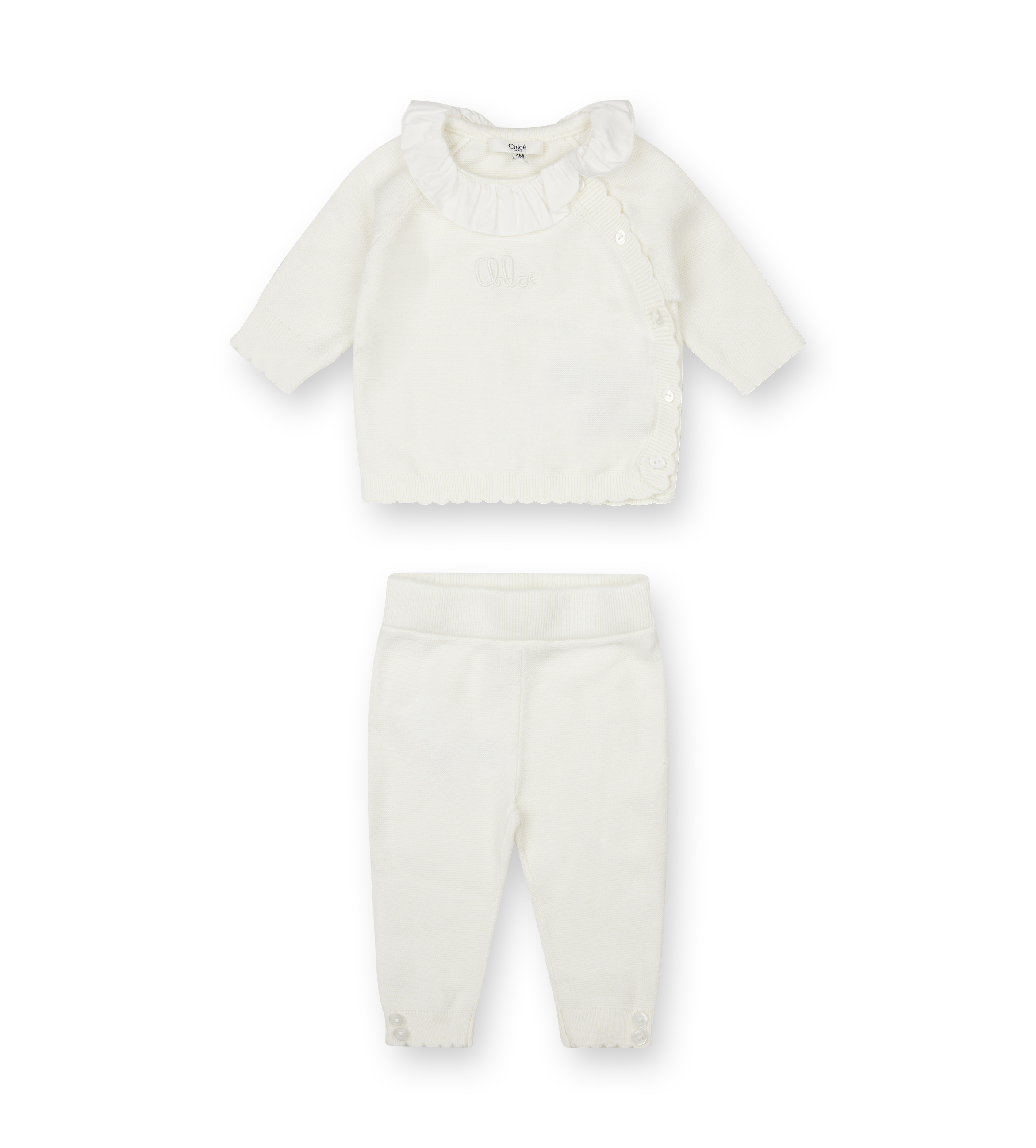 White baby outfit with shirt and pants on a white background