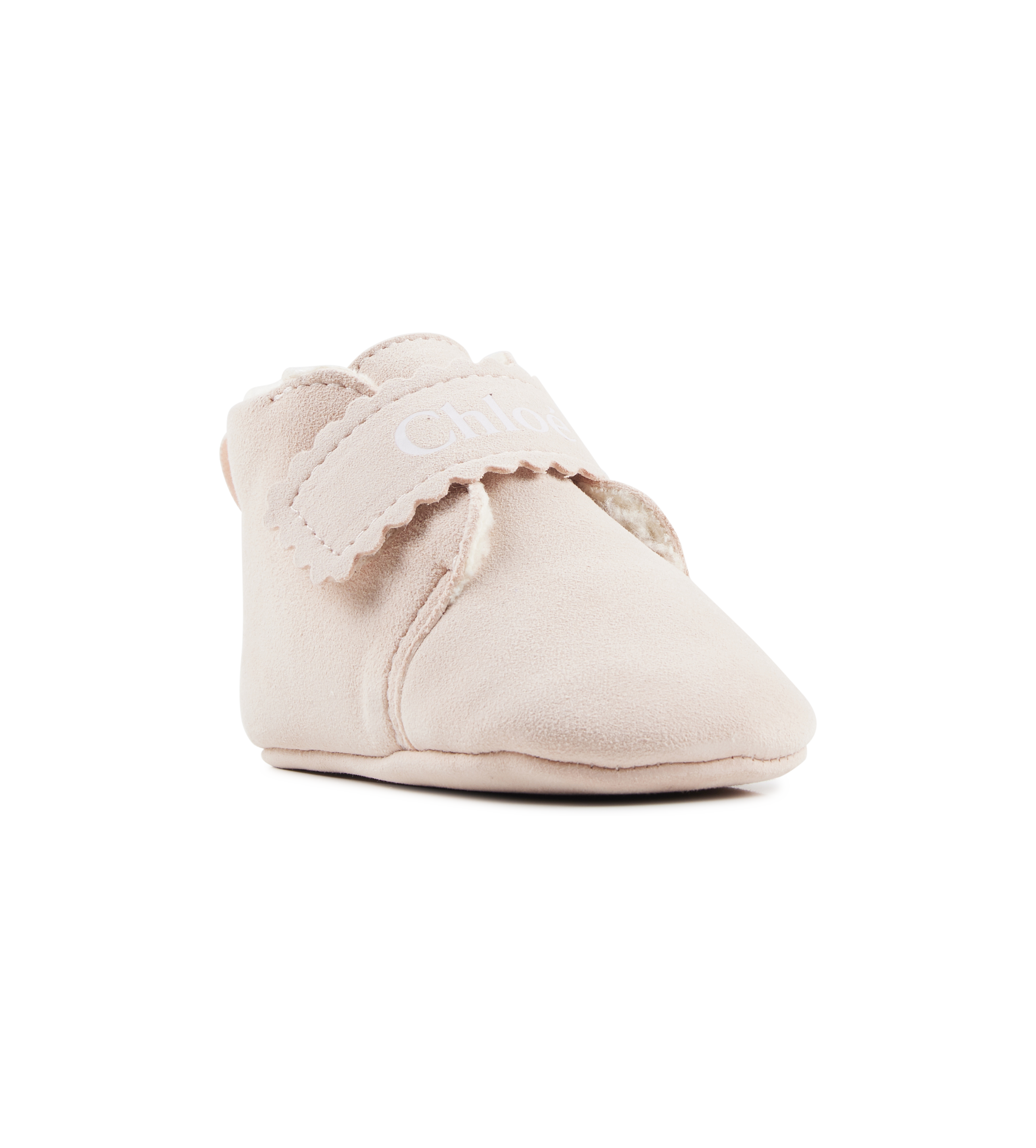 Beige baby shoe with ruffle on a white background