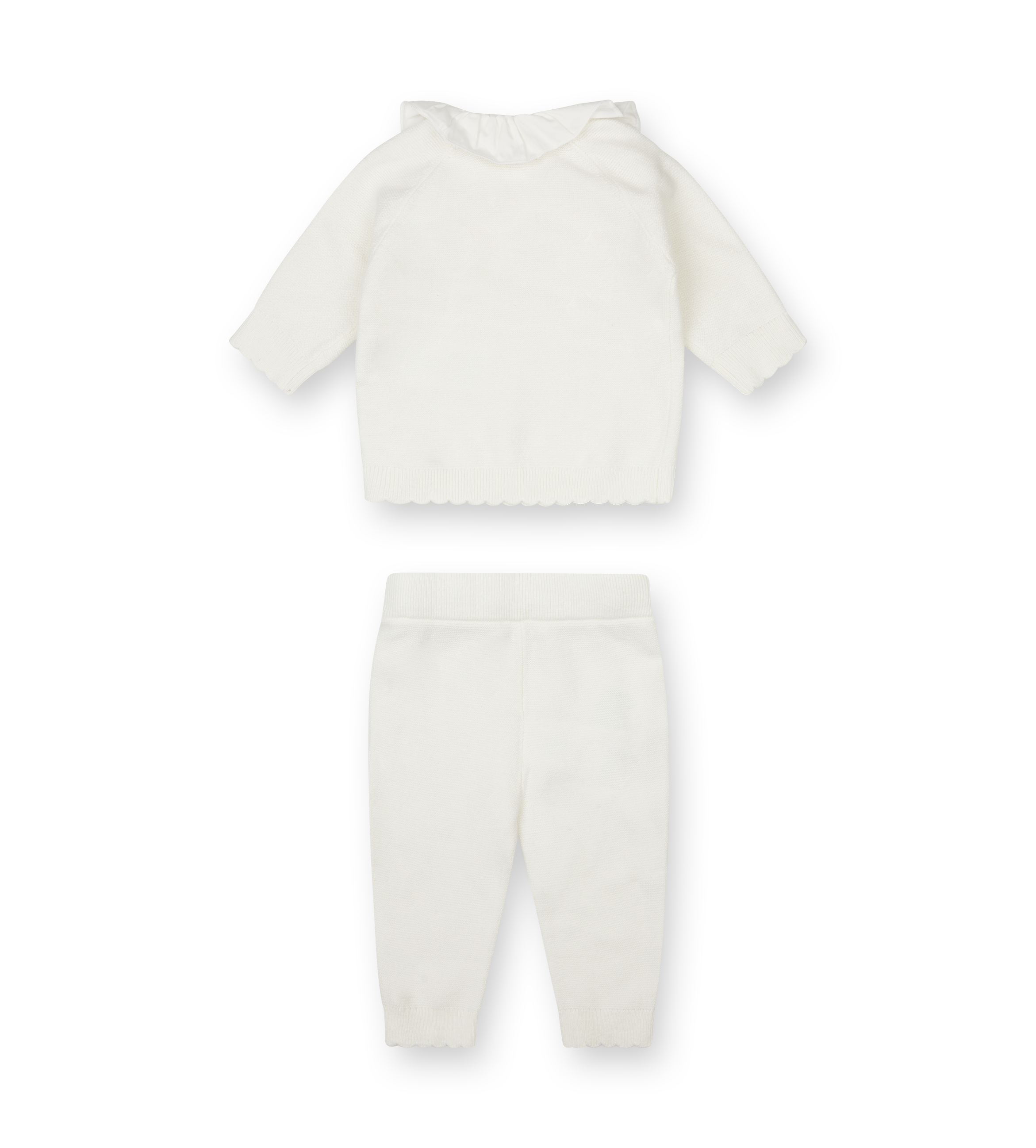 White baby outfit with top and pants on a white background