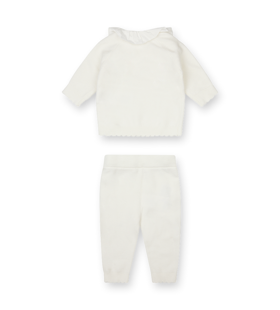 White baby outfit with top and pants on a white background