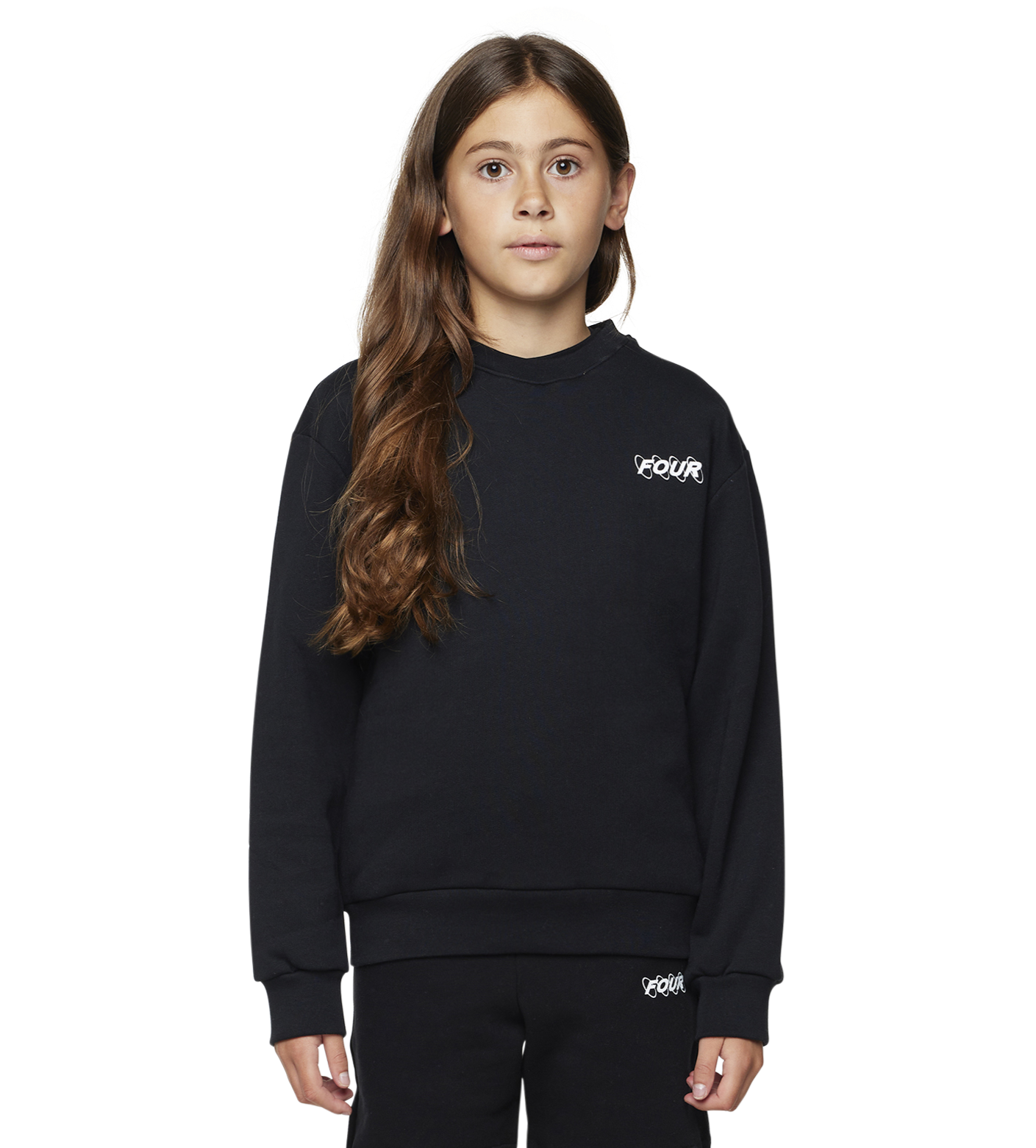 Young girl wearing a black outfit with a brand logo on a white background