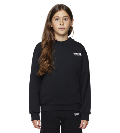 Young girl wearing a black outfit with a brand logo on a white background