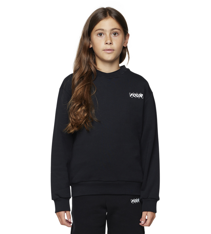 Young girl wearing a black outfit with a brand logo on a white background