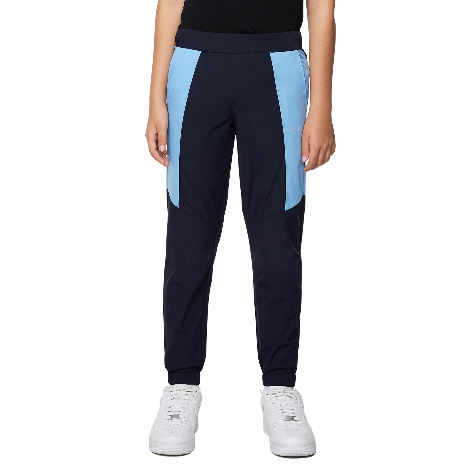 Person wearing a black tank top and navy jogger pants with light blue accents on a white background