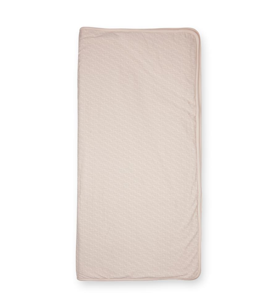 Quilted beige pad on a white background