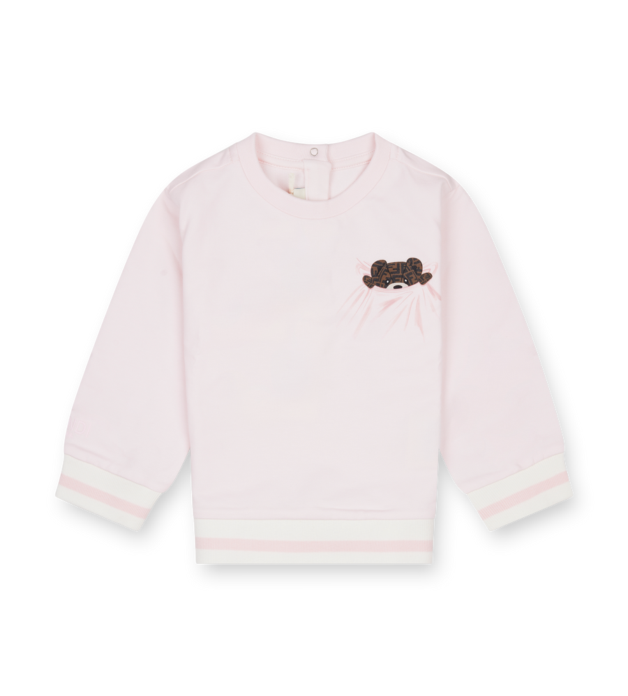 Pink sweater with a black and white design on a white background