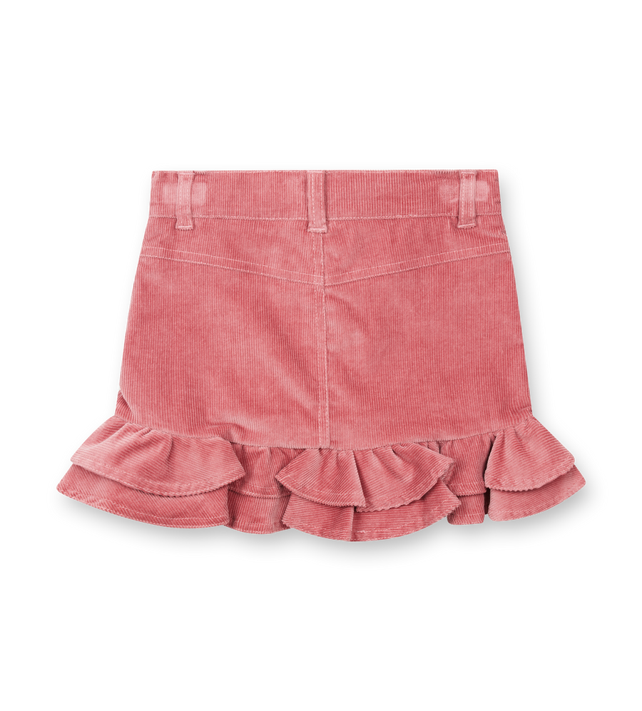 Pink corduroy skirt with ruffled hem on a white background