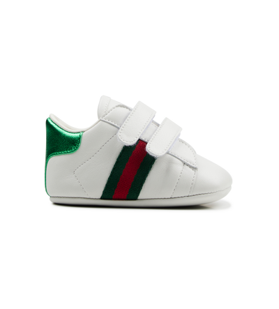 white baby shoe with green and red stripes