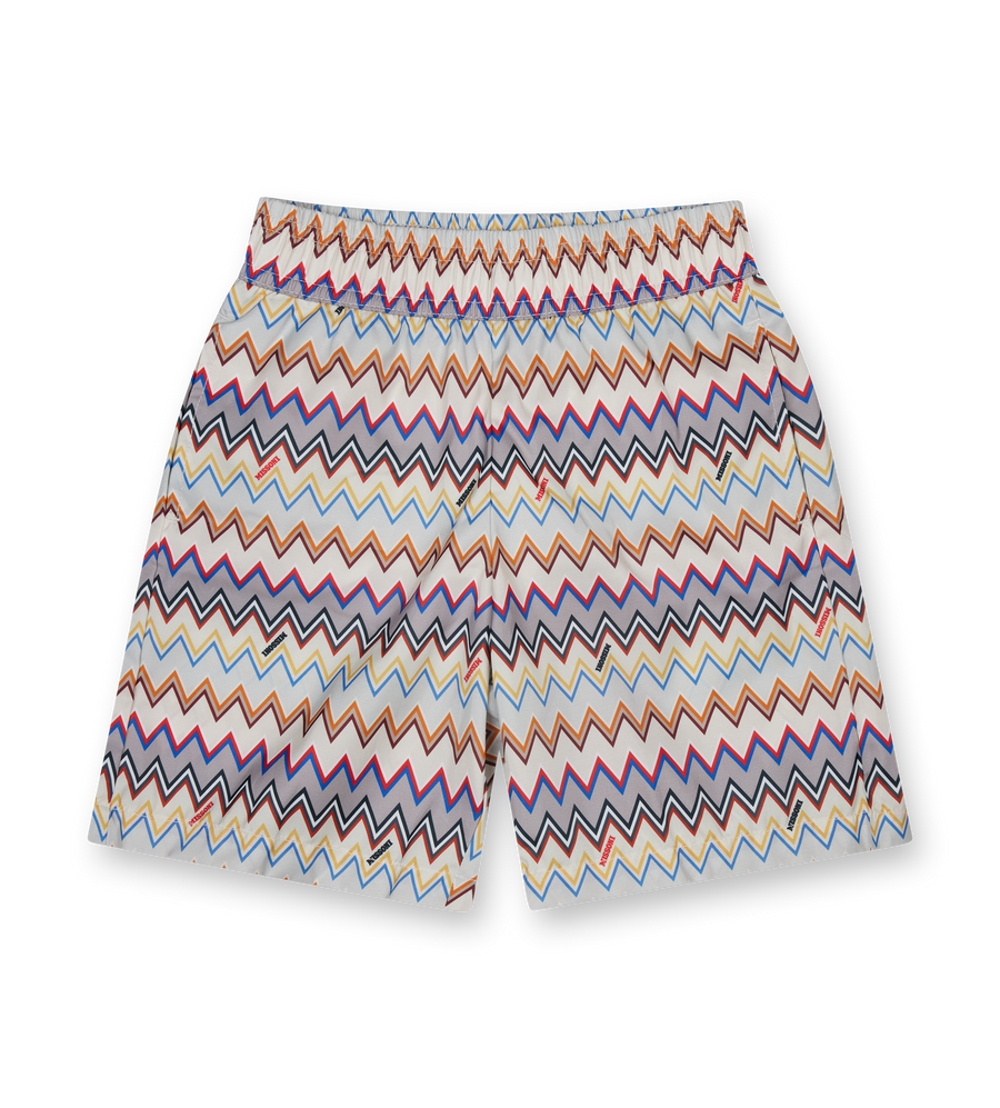 Colorful zigzag patterned shorts on a white background