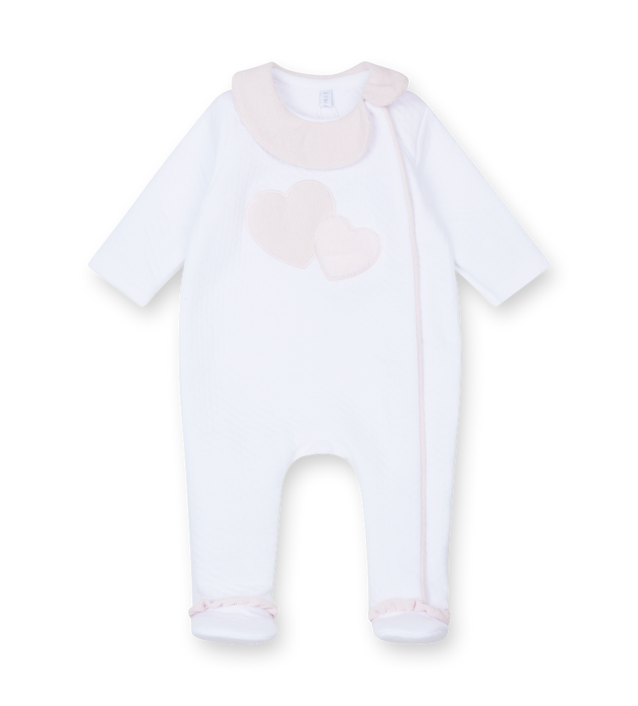 White baby onesie with a heart design on a white background