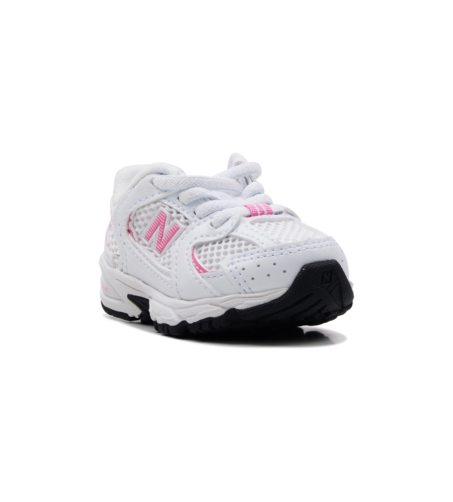 White children's sneaker with pink accents on a white background
