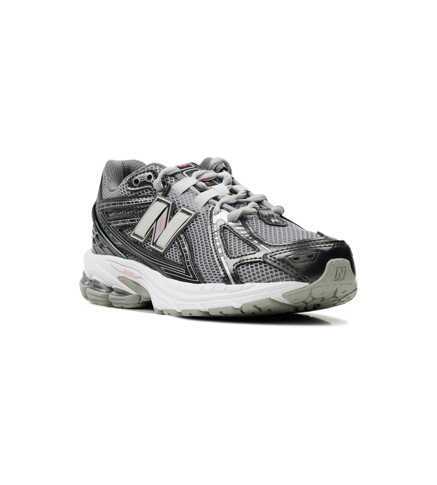Gray and black athletic shoe with New Balance logo on a white background