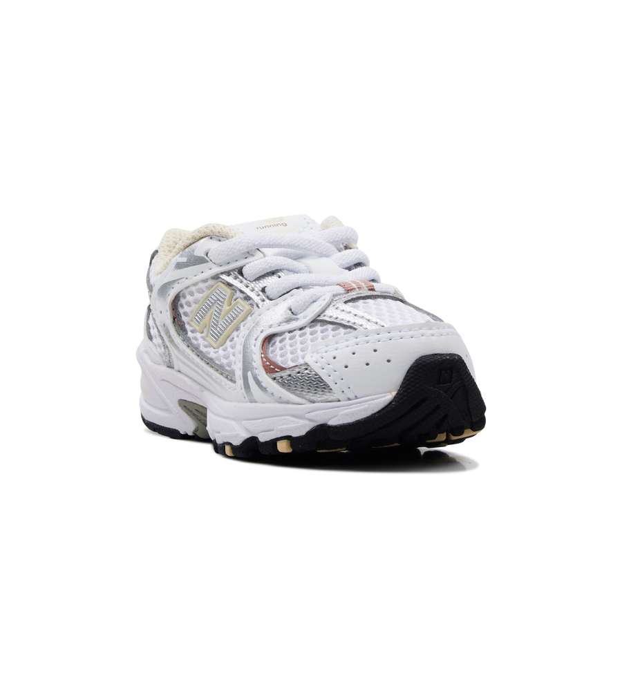 White athletic shoe with black sole on a white background