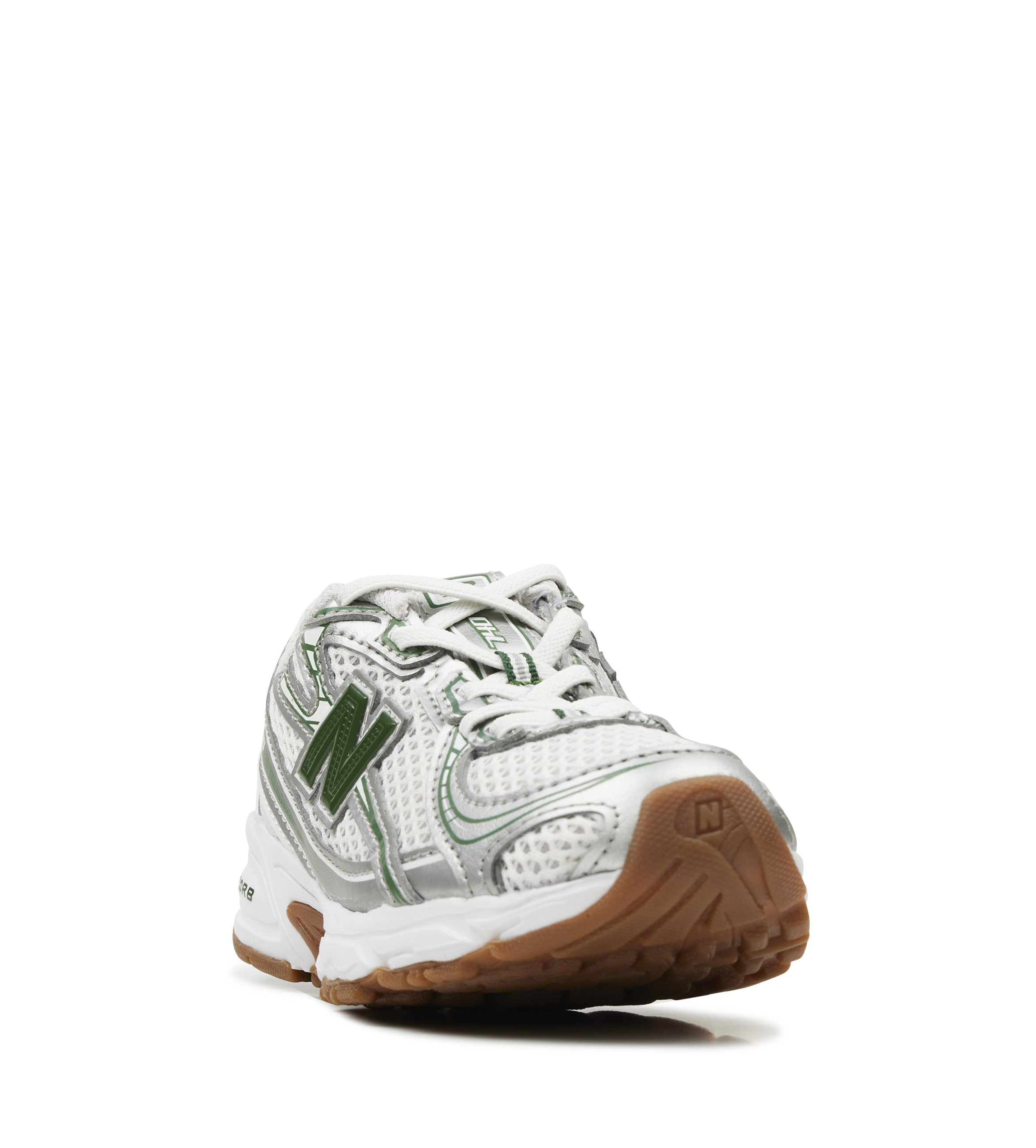 White sneaker with green accents and brown sole on a white background