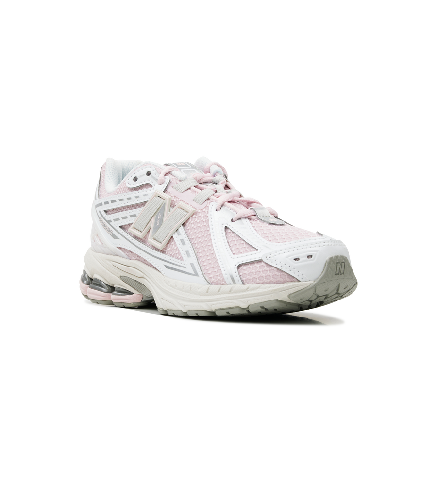 White athletic shoe with pink accents on a white background