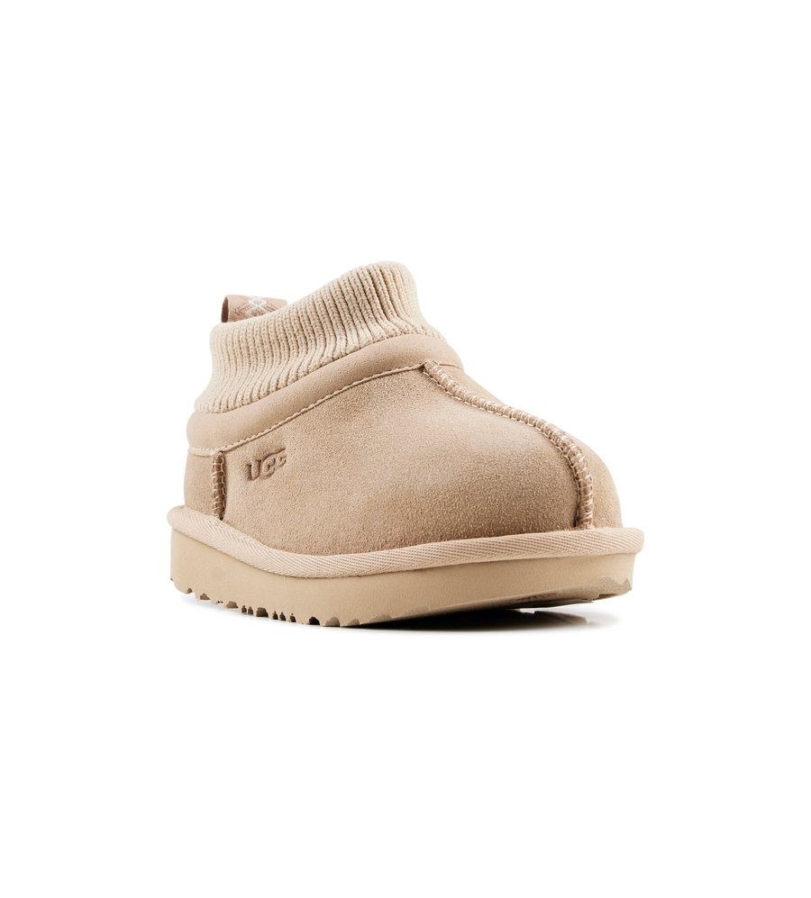 Beige UGG boot on a white background