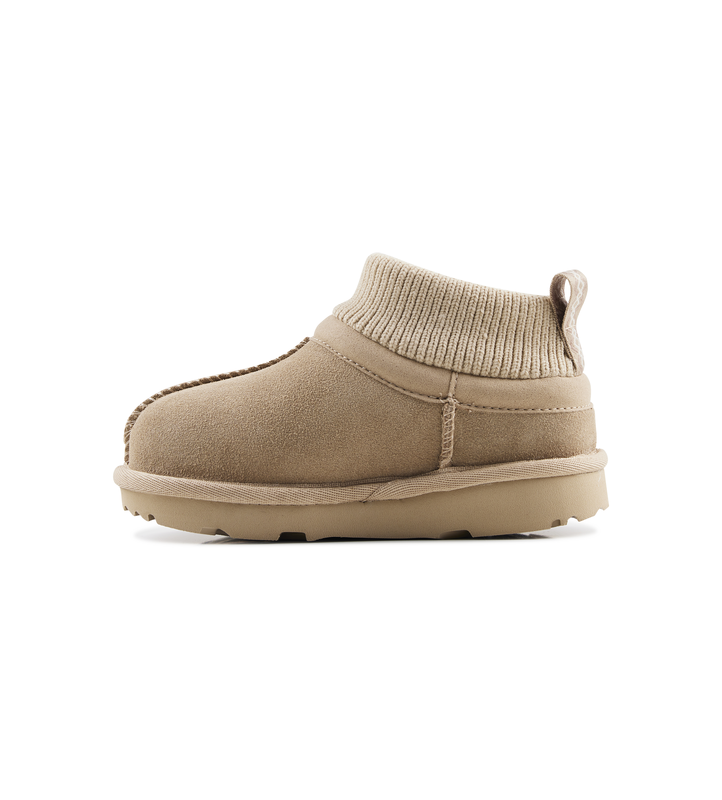 Beige slip-on shoe with knit cuff on a white background