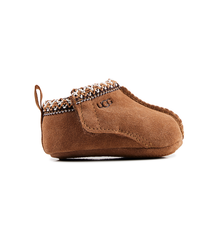 Brown baby bootie with decorative trim on a white background