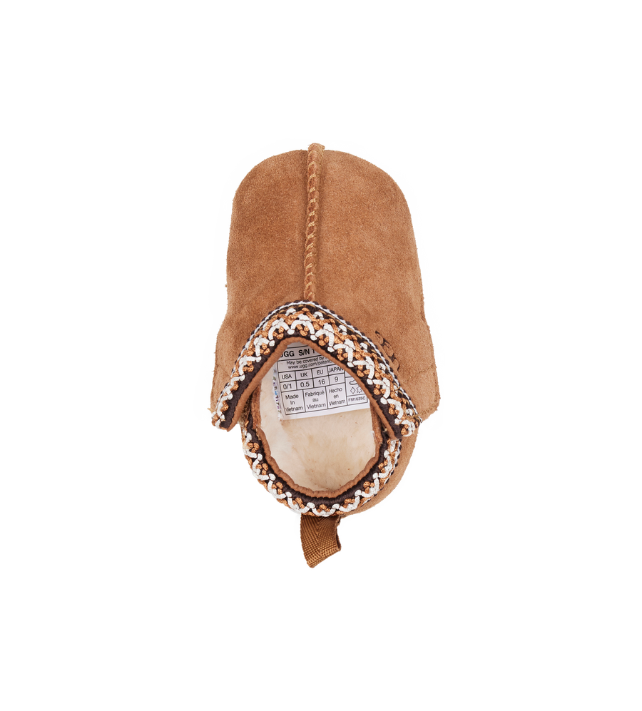 Brown baby bootie with a patterned band on a white background