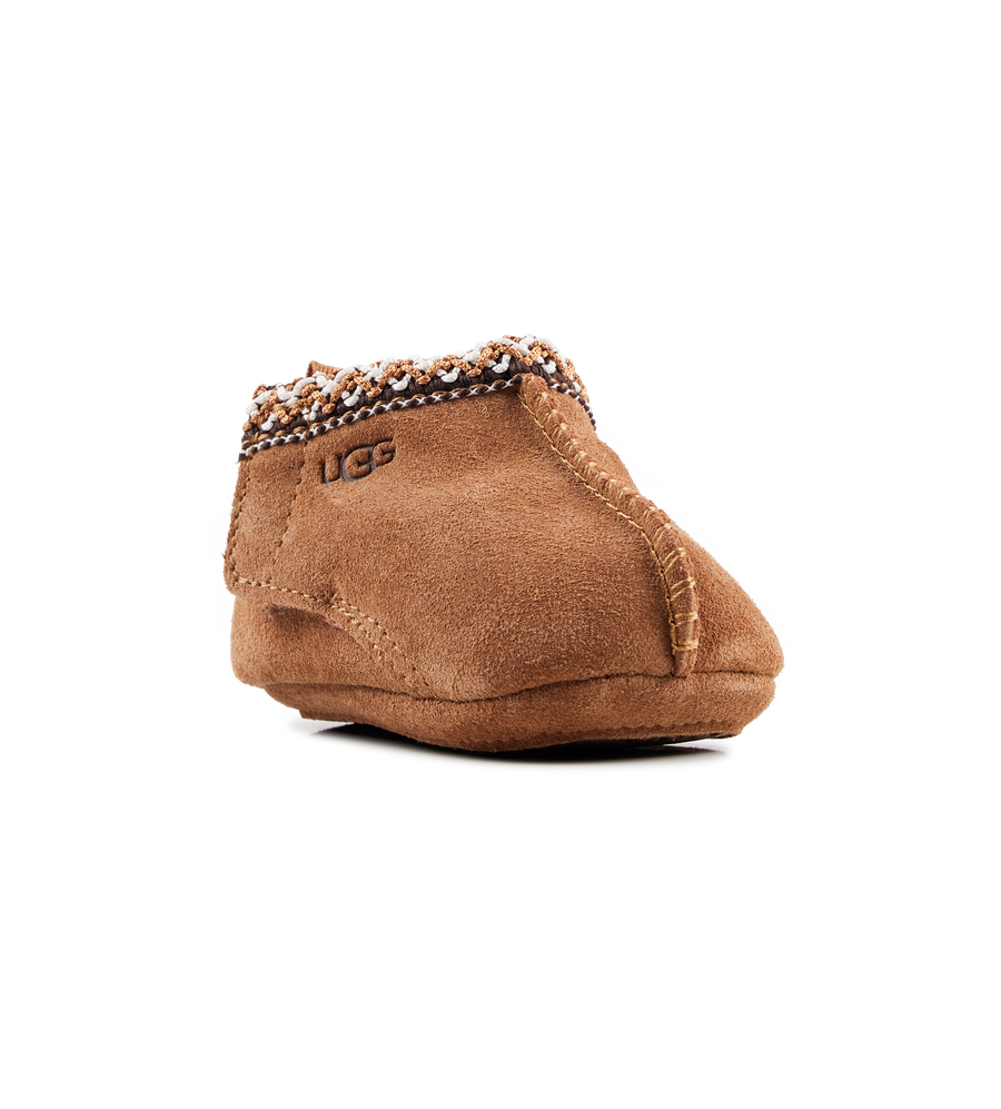 Brown UGG slipper on a white background