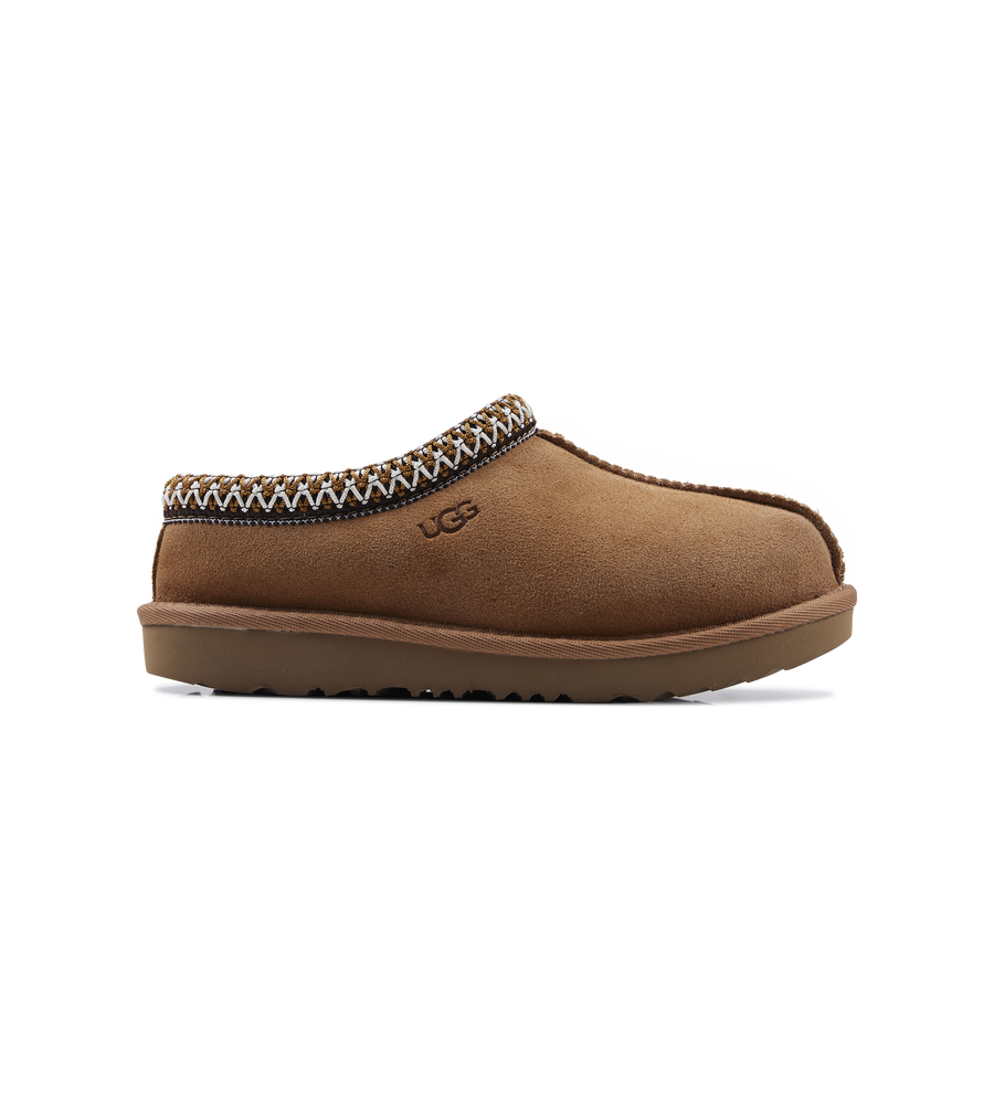 Brown UGG slipper with decorative trim on a white background
