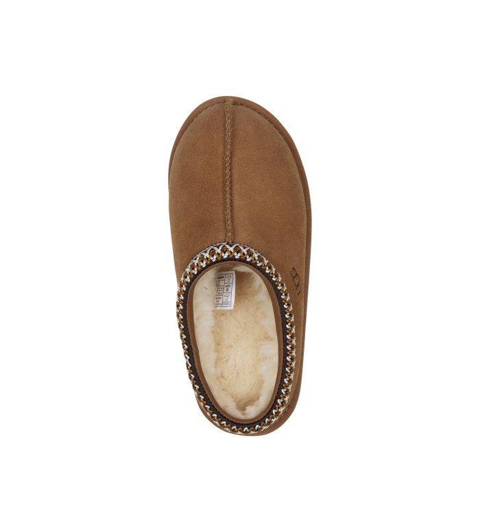 Brown slipper with decorative trim on a white background