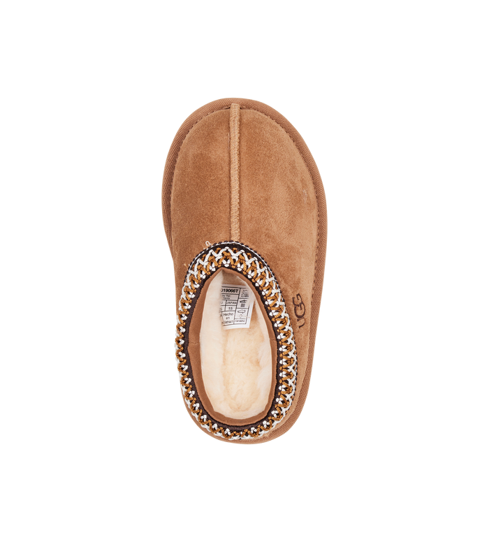 Brown slipper with decorative trim on a white background