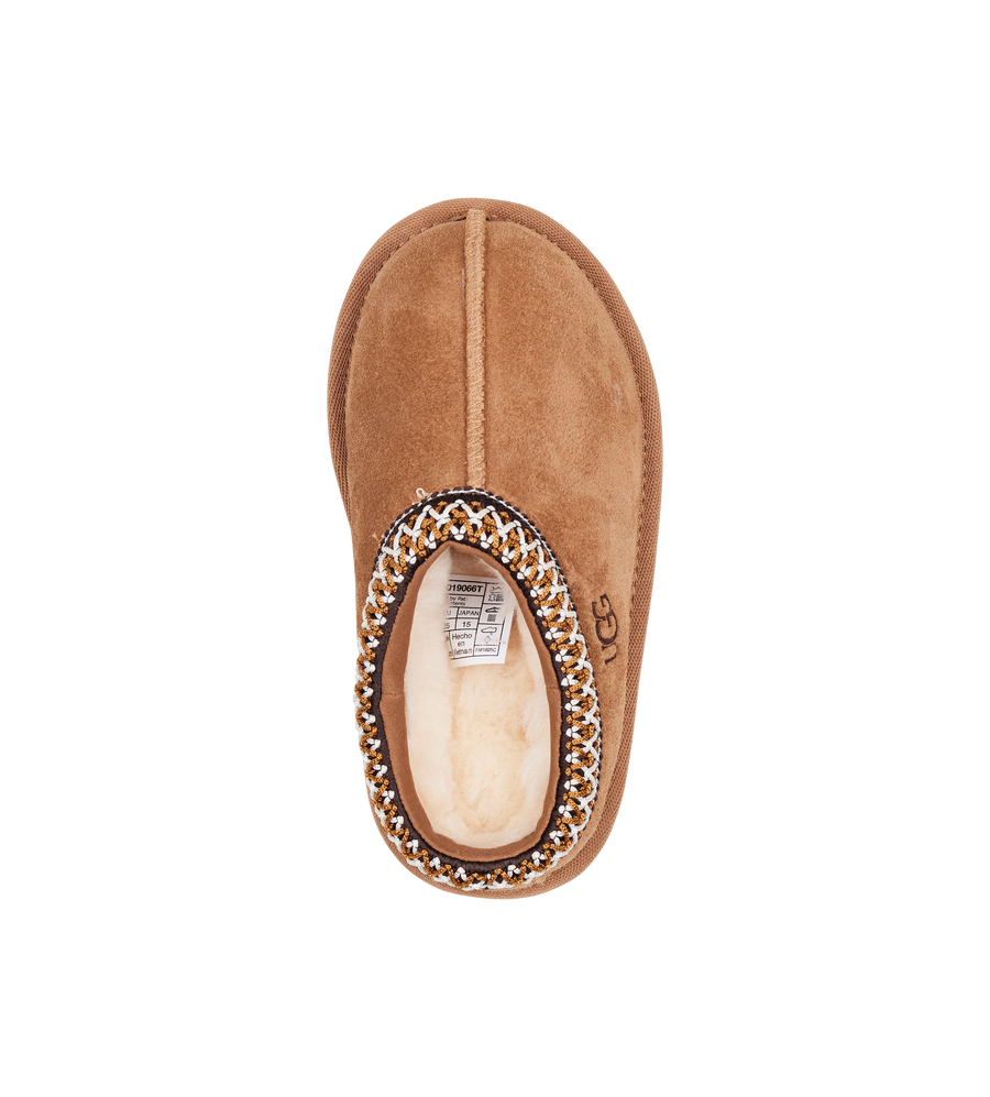 Brown slipper with decorative trim on a white background