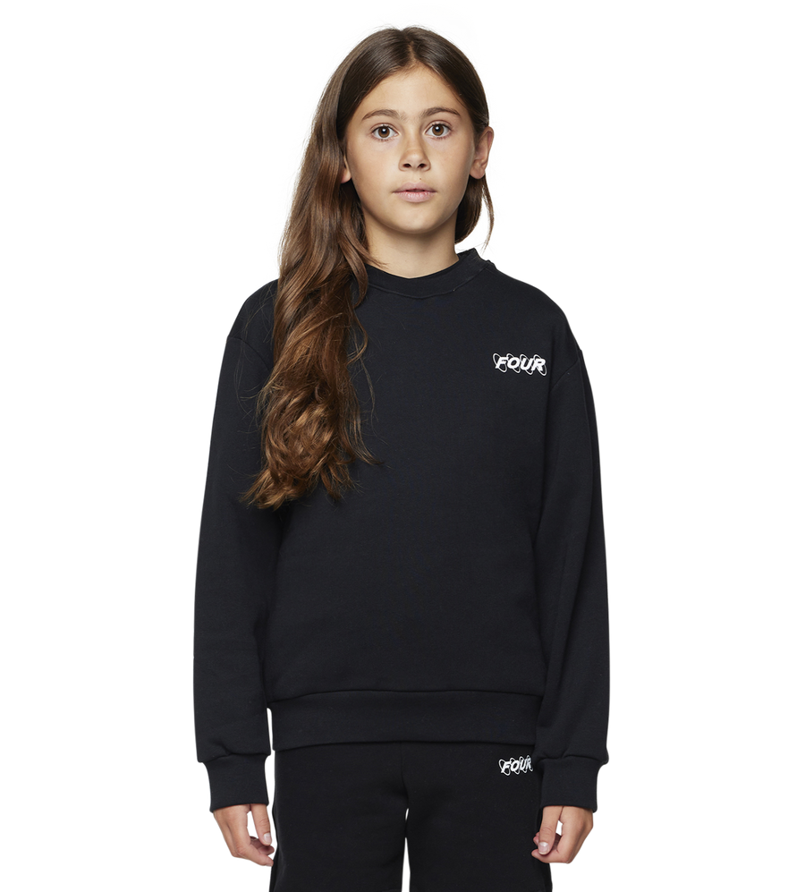 Young girl wearing a black outfit with a brand logo on a white background
